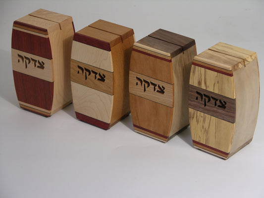 Set of four EC13 tzedakah boxes, left to right: EC13A bloodwood/maple, EC13B maple/cherry, EC13C cherry/cherry, EC13D spalted maple/walnut; arched profile with inlaid hardwood strips.
